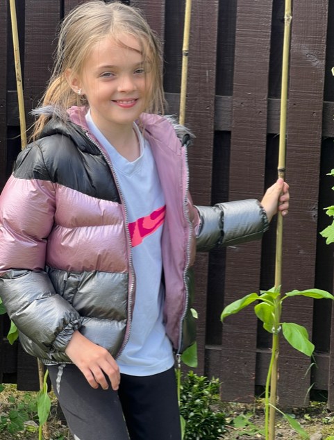 John M and Emily planting her sunflowers outside